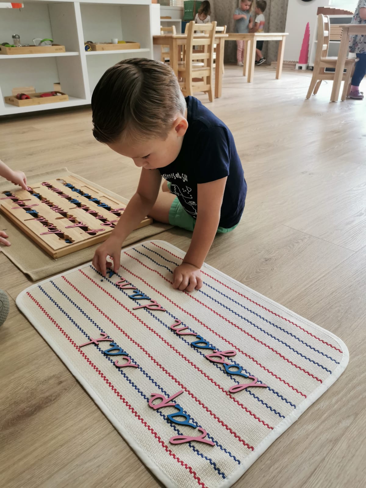 Primary child learning how to read and write at the Educational Transitional Kindergarten program at Shadowridge Montessori School