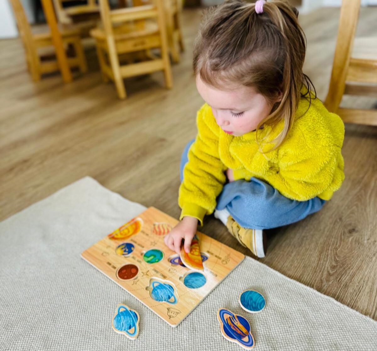 Primary child learning how the 5 Montessori Learning Areas Prepare them for Life
